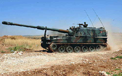 Turkish soldiers on a self-propelled howitzer at the border between Turkey and Syria, From ImagesAttr