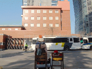 Japanese Embassy in Seoul and watched from behind a bronze statue of comfort women, From WikimediaPhotos