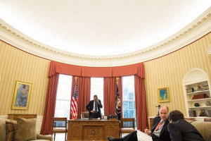 President Barack Obama talks on the phone in the Oval Office, March 1, 2013. National Security Advisor Tom Donilon and Deputy National Security Advisor Tony Blinken listen at right., From ImagesAttr