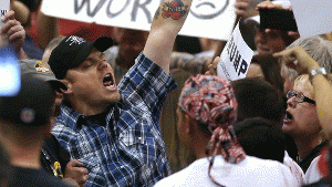 Protesters shout as they are forcibly removed from a Donald Trump campaign rally in Tucson, Ariz. on Saturday.