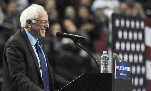 Bernie Sanders smiles as a bird lands on his podium, From ImagesAttr