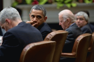 President Barack Obama, with Vice President Joe Biden, attends a meeting in the Roosevelt Room of the White House, Dec. 12, 2013.