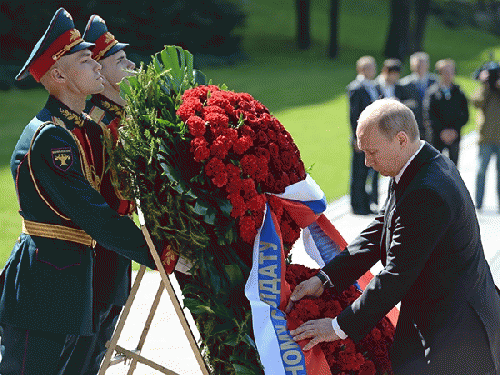 Russian President Vladimir Putin laying a wreath at Russia's Tomb of the Unknown Soldier on May 8, 2014, as part of the observance of the World War II Victory over Germany., From ImagesAttr