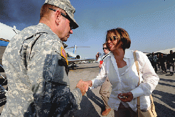 During a Congressional delegation to Haiti, U.S. Rep. Nancy Pelosi gives a warm smile and firm handshake to a fellow American involved with peacekeeping efforts on the Caribbean island., From FlickrPhotos