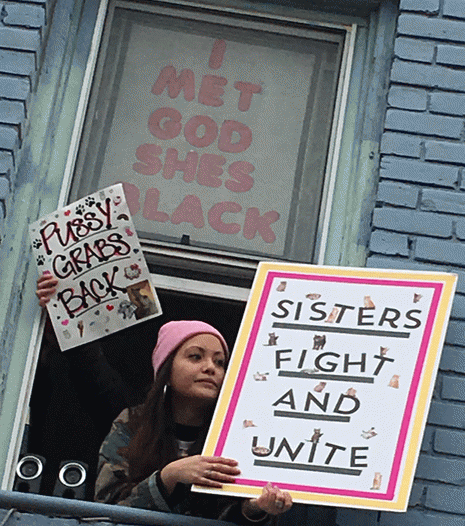 Signs from a second story window at the Sister march, Norfolk VA. 01.21.17