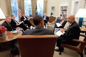 Director of National Intelligence James Clapper (right) talks with President Barack Obama in the Oval Office, with John Brennan and other national security aides present.