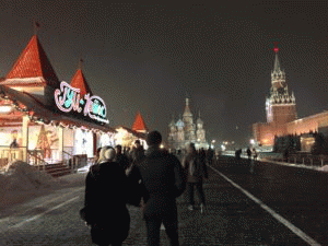 Red Square in Moscow with a winter festival to the left and the Kremlin to the right.