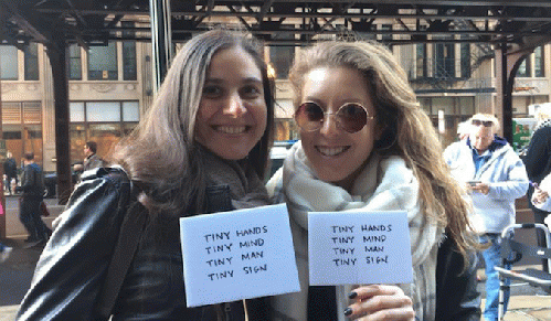 Yael and friend Alison with tiny signs