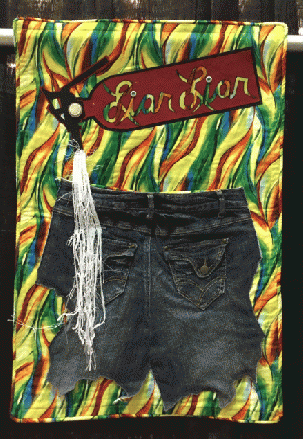 Liar, Liar, Pants on Fire. The blue jeans used in the art quilt were actually set on fire before stitching them into the quilt.
