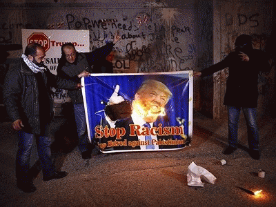 Protesters in Bethlehem burning a poster of Trump over his plan to move the US embassy to Jerusalem., From ImagesAttr