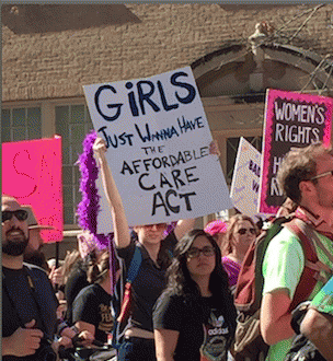 sign reads: Girls just wanna have the Affordable Care Act