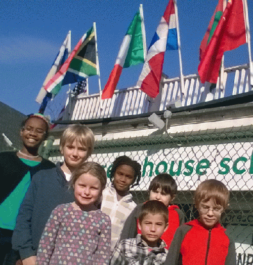 Greenhouse School students proudly pose with flag display