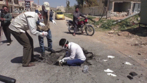 Photograph of men in Khan Sheikdoun in Syria, allegedly inside a crater where a sarin-gas bomb landed., From ImagesAttr