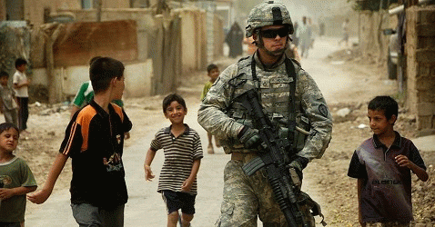 Iraqi children gather around as U.S. Army sergeants patrol the streets of Al Asiriyah, Iraq., From ImagesAttr