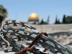 One of Islam's holiest sites the Dome of the Rock in Jerusalem, seen through barbed wire., From ImagesAttr