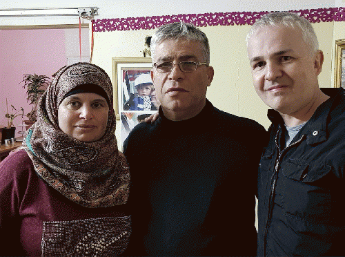 Manal Tamimi with her husband Bilal and Paul Heron, in Manal and Bilal's home