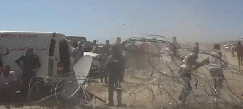 Dust billows as Palestinian protesters drag a ripped-down section of fence on the Gaza border earlier this year. Seven Palestinians killed by Israeli forces last Friday were among roughly 200 Gazans slain at the border since protests intensified early in 