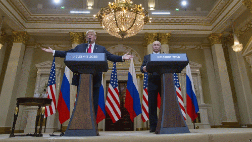 U.S. President Donald Trump, left, gestures while speaking as Russian President Vladimir Putin, right, listens during their joint news conference at the Presidential Palace in Helsinki, Finland, July 16, 2018.