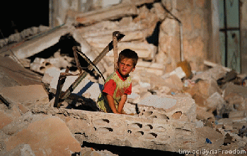 A child looking at what happened to his family house in Idlib after it was bombed