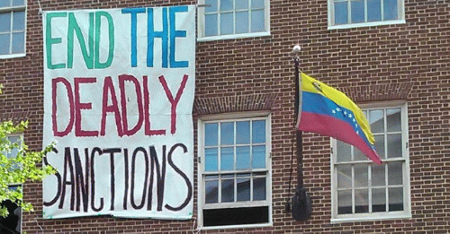 The Embassy Protectors have decorated the Venezuelan Embassy with signs and banners that are giving the Georgetown neighbors a good education. A large banner right above the Venezuelan flag says 