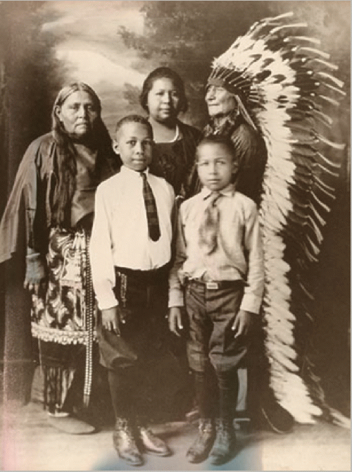 Comanche family, early 1900s  Here is a family from the Comanche Nation located in southwestern Oklahoma. The elder man in Comanche traditional clothing is Ta-Ten-e-quer. His wife, Ta-Tat-ty, also wears Comanche clothing. Their niece (center) is Wife-per,, From Uploaded