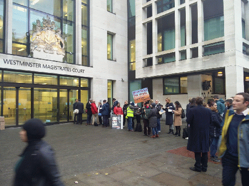 Protestors line up at courthouse Monday morning.