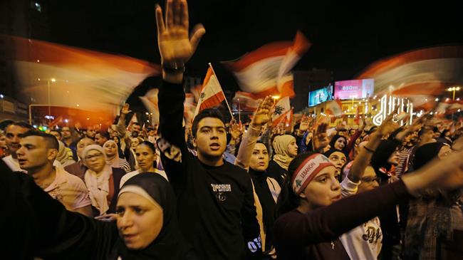 Lebanese protesters wave flags and shout slogans during an anti-government demonstration at al-Nour Square in the northern port city of Tripoli on November 2, 2019. Lebanese protesters wave flags and shout slogans during an anti-government demonstration at al-Nour Square in the northern port city of Tripoli on November 2, 2019.
