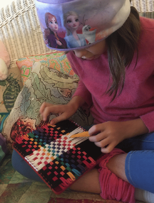 Myla making a potholder on her Harrisville Potholder  Loom