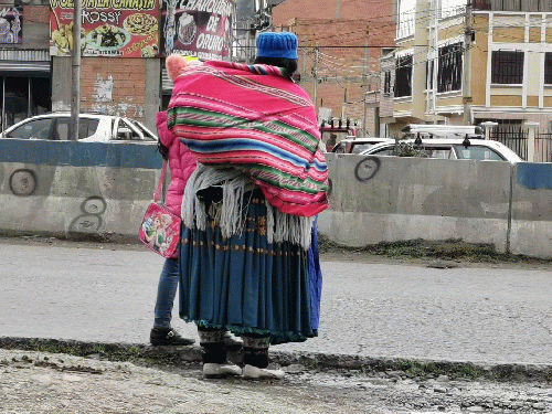 indigenous woman and bullet holes marked, in El Alto