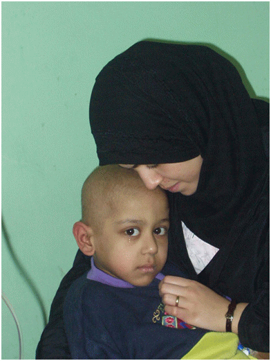 Adra and her 5-year-old son Atarid in hospital. Atarid suffered from cancer. He died on the 3rd day of the United States Shock and Awe bombing.