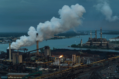 Inequality means that some people must live near sources of air pollution, such as a steel mill, in Detroit—which in turn weakens their lungs and means that they can't fight off COVID-19., From Uploaded