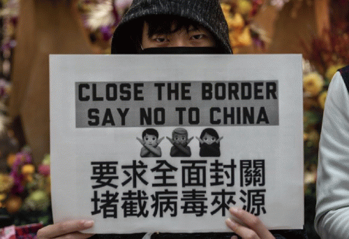 A picture of a member of Hong Kong's pro-U.S. fascist movement. Their sign is a response to Covid-19., From Uploaded