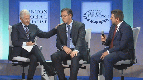 Vucic being patted on the back condescendingly by Clinton