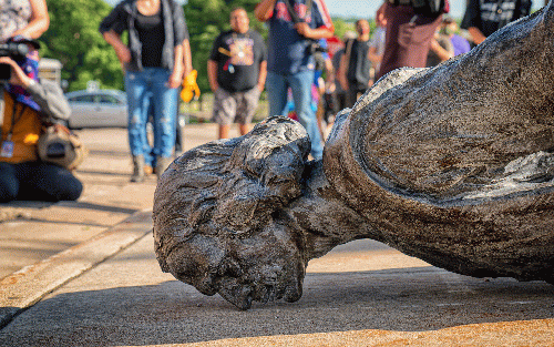 The fallen Christopher Columbus statue outside the Minnesota State Capitol after a group led by American Indian Movement members tore it down