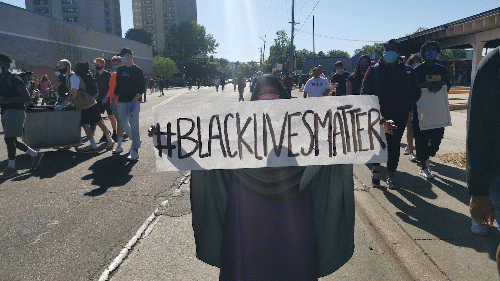 Woman on the streets of Minneapolis holds #BlackLivesMatter sign., From Uploaded