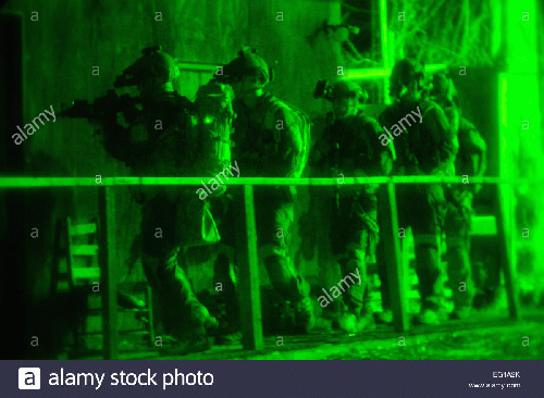 Drug Enforcement Administration agents prepare to breach a building during a drug raid on a high value target., From Uploaded