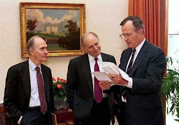 President George H. W. Bush examines papers with Sec. Dick Cheney and Gen. Brent Scowcroft in the Oval Office, April 19, 1989., From InText