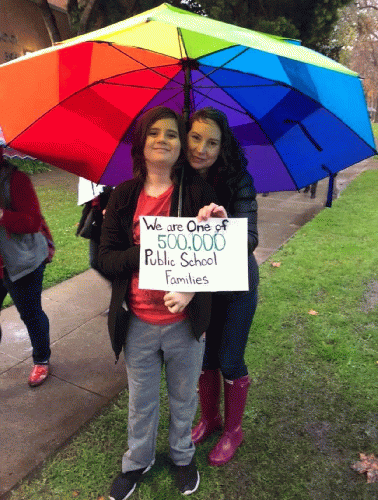 Dore with one of her children supporting Los Angeles teachers during the 2019 strike