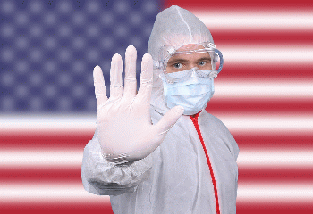 From live.staticflickr.com: Doctor or Nurse Wearing Medical Personal Protective Equipment (PPE) Against The Flag Of USA  