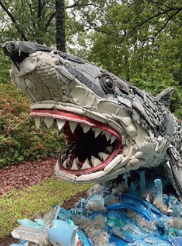 Shark sculpture by Washed Ashore. Note identifiable trash items in the shark such as shoe soles. Shark sculpture by Washed Ashore. Note identifiable trash items in the shark such as shoe soles.