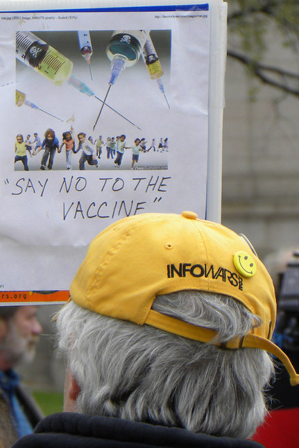 An anti-vax protester and his fearful sign