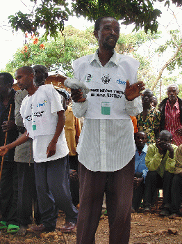 From live.staticflickr.com: Community health worker addresses villagers during the distribution of ivermectin. BURUNDI  