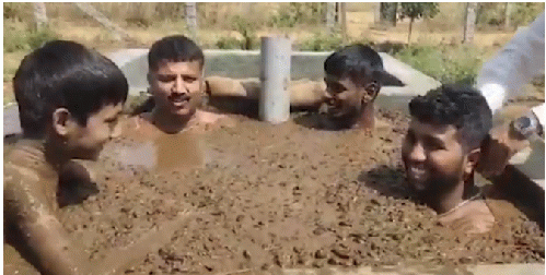 People of India in Fresh Cow dung to cure COVID