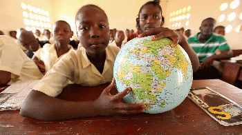 A student holds a globe of the world in class, From CreativeCommonsPhoto