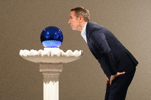 Jeff Koons gazes at a blue ball