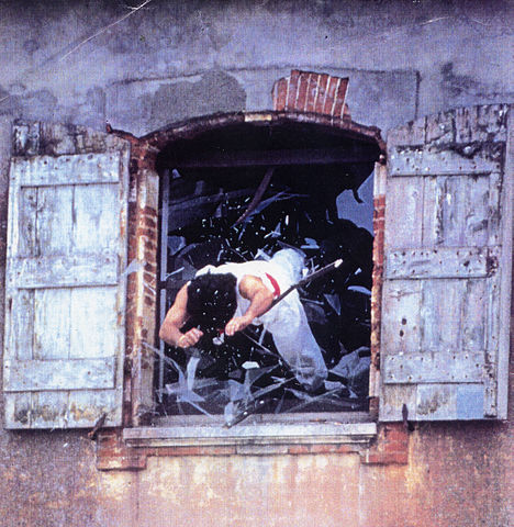 A stuntman diving out a window