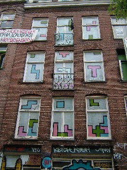 Tetris continues to cross boundaries after the fall of the Berlin wall, as seen on the windows of a squat in Amsterdam. Photo by sprklg via Flickr.