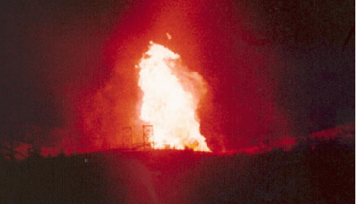 Figure 5: Carlsbad explosions. At the lower left of a fireball, the 85-foot-tall support structures for the pipeline suspension bridges can be seen. Corrosion was grasped as an explosion cause., From Uploaded