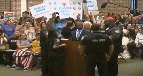 Tony Thurmond is surrounded by School Safety officers., From Uploaded