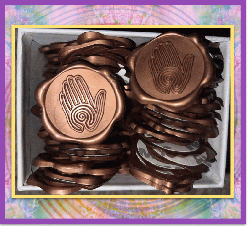 Maia's metallic wax seal stickers stamped with her spiral  hand labyrinth pattern.